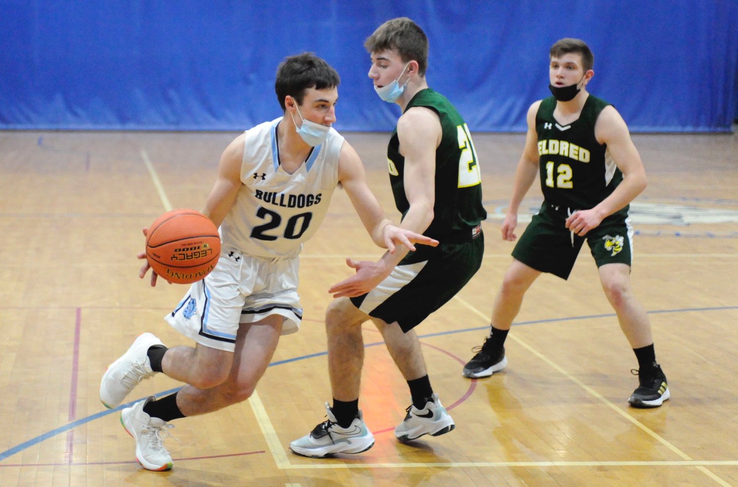 Cutting it close. Sullivan West’s Andrew Huber drives to the glass against Eldred’s Josh Warming and Matthew Ranaudo.